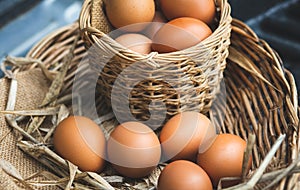 Fresh chicken eggs in a basket and carton box.