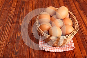 Fresh chicken eggs in the basket put on vintage tablecloth
