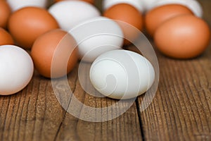 Fresh Chicken eggs and duck eggs on wooden background - white and brown egg