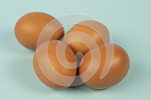 Fresh chicken eggs on turquoise background