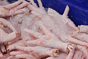 Fresh chicken feet for cooking in market