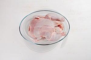 Fresh chicken in roasting pan,