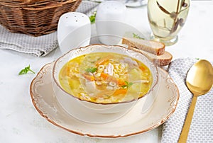 Fresh chicken soup with vegetables and stelline pasta in a bowl with