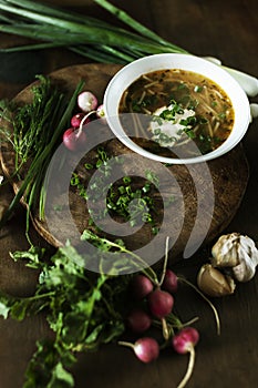 Fresh chicken soup on wooden table