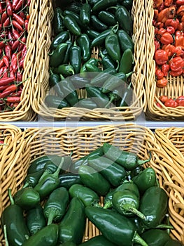 Fresh chillies variety piled in the baskets on the market. Jalapeno pepper with some Birdseye chillies and Habanero chillies on