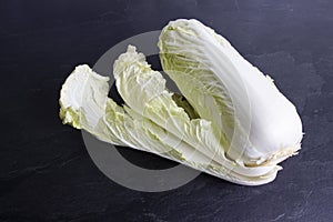 Fresh chinese cabbage and leaves on black background