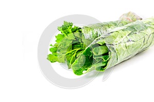 Fresh chinese kale vegetables wrapped in plastic film isolated