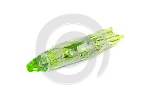 Fresh chinese kale vegetables wrapped in plastic film isolated