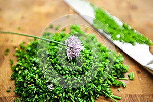 Fresh chives on a wooden cutting board, selective focus