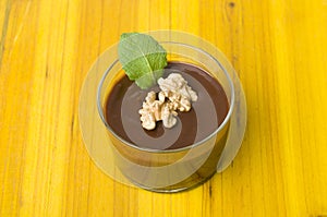 Fresh chocolate mousse with walnut and mint.