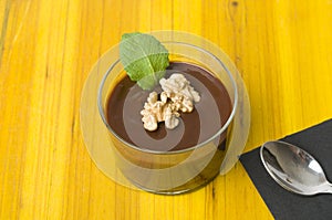 Fresh chocolate mousse with walnut and mint.