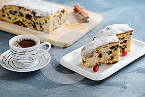 Fresh christmas stollen with raisins and a cup of coffee.