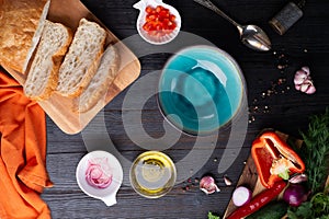 Fresh ciabatta bread  with blue bowl and ingredients served at dark wooden table. meditarranean cuisine. flat lay
