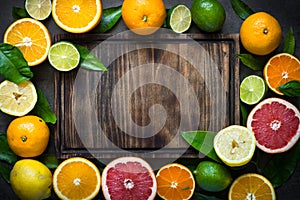 Fresh citrus fruit assortment on black.