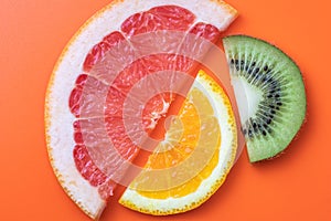 Fresh citrus fruit background. Slices of kiwi, orange and grapefruit. Fun summer concept