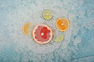 Fresh citrus fruit slices over crushed ice