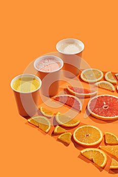 Fresh citrus juices orange, grapefruit, lemon with citrus fruits. concept on orange background. isolate. Take away