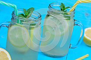 Fresh citrus lemonade in mason jars on table photo
