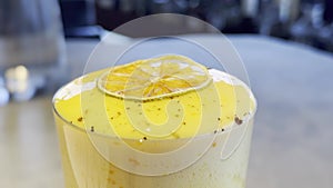 Fresh citrus smoothie with slice topping in daylight