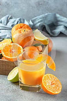 Fresh citruses. Tangerines, lime, lemon and juice glass