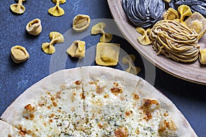 Fresh classic italian pizza with pasta and Cutlery, top view, flat lay