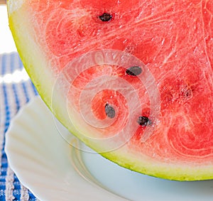 Fresh and clean cut watermelon with blurred background. Concept of freshness and summer time on the beach photo