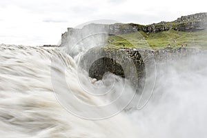 Fresh clean Dettifoss waterfall in Iceland in summer with loads of water flowing and mist,