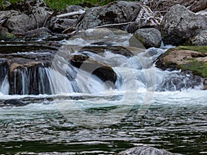 Fresh clean water running over rocks creating small waterfalls