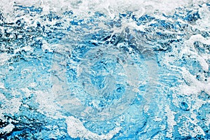 Fresh clear blue water texture closeup, sea waves pattern, ocean surface, transparent pure water splash, white foam bubbles, drops