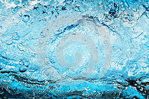 Fresh clear blue water texture closeup, sea waves pattern, ocean surface, transparent pure water splash, white foam bubbles, drops