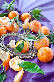 Fresh clementines on purple