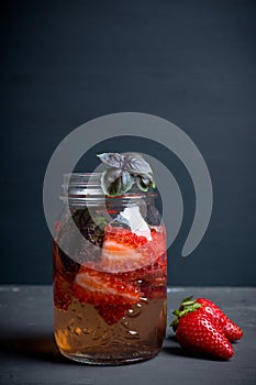 Fresh cocktail with strawberry and basil in glass