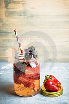 Fresh cocktail with strawberry and basil in glass