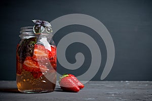 Fresh cocktail with strawberry and basil in glass