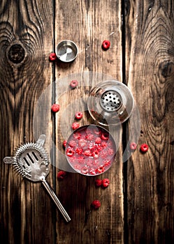 Fresh cocktail of wild raspberries in a shaker.