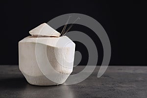 Fresh coconut drink in nut on table