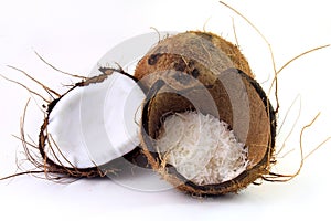 Fresh coconut flakes placed in bark and shell isolated on white background