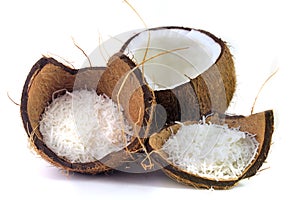 Fresh coconut flakes placed in bark and shell isolated on white background