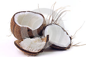Fresh coconut flakes placed in bark and shell  on white background
