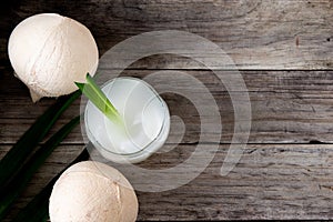 Fresh coconut juice in a glass with coconut white meat isolated on white