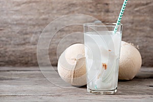 Fresh coconut juice in a glass with coconut white meat isolated on white