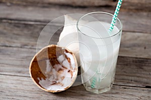 Fresh coconut juice in a glass with coconut white meat isolated on white