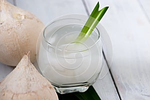 Fresh coconut juice in a glass with coconut white meat isolated on white