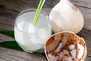 Fresh coconut juice in a glass with coconut white meat isolated on white