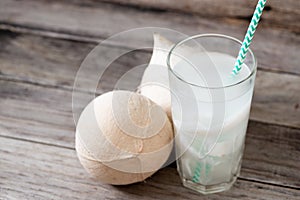 Fresh coconut juice in a glass with coconut white meat isolated on white