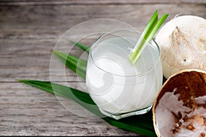 Fresh coconut juice in a glass with coconut white meat isolated on white