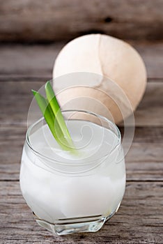 Fresh coconut juice in a glass with coconut white meat isolated on white