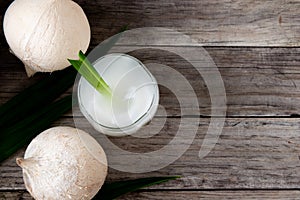 Fresh coconut juice in a glass with coconut white meat isolated on white