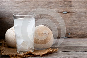 Fresh coconut juice in a glass with coconut white meat isolated on white