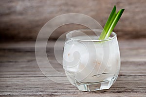 Fresh coconut juice in a glass with coconut white meat isolated on white